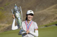 Saki Baba, of Japan, poses for photos with the trophy after she won the USGA Women's Amateur Golf Championship, Sunday, Aug. 14, 2022, at Chambers Bay in University Place, Wash. (AP Photo/Ted S. Warren)