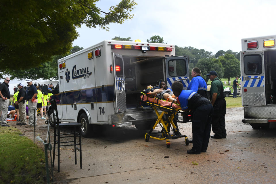 A spectator is taken to an ambulance after a lightning strike on the course which left several injured during a weather delay in the third round of the Tour Championship golf tournament Saturday, Aug. 24, 2019, in Atlanta. (AP Photo/John Amis)