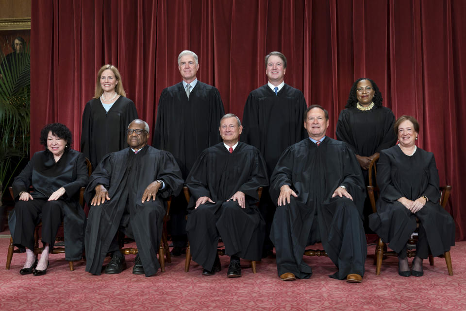 FILE - Members of the Supreme Court sit for a new group portrait following the addition of Associate Justice Ketanji Brown Jackson, at the Supreme Court building in Washington, Oct. 7, 2022. Bottom row, from left, Justice Sonia Sotomayor, Justice Clarence Thomas, Chief Justice of the United States John Roberts, Justice Samuel Alito, and Justice Elena Kagan. Top row, from left, Justice Amy Coney Barrett, Justice Neil Gorsuch, Justice Brett Kavanaugh, and Justice Ketanji Brown Jackson. (AP Photo/J. Scott Applewhite, File)