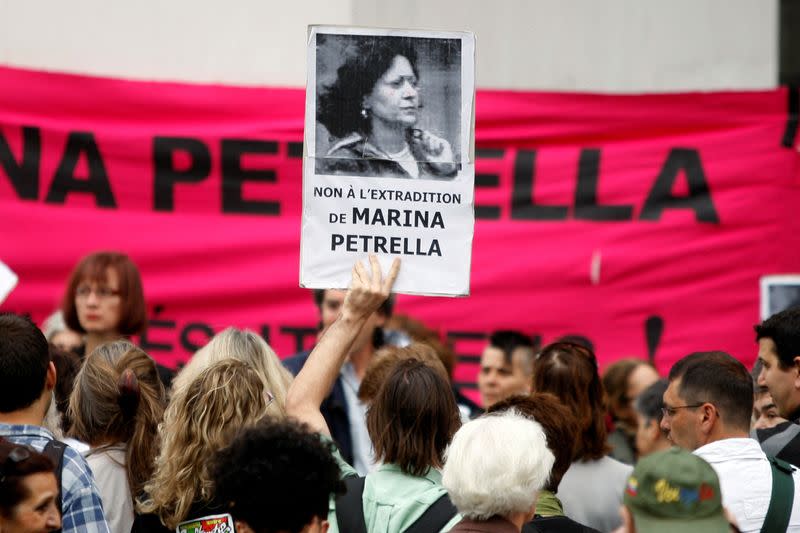 FILE PHOTO: A demonstrator holds up a portrait of former member of the Red Brigades Marina Petrella during a protest in Paris