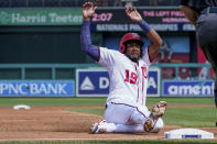 Washington Nationals' Josh Bell slides into third base during the third inning of a baseball game against the Colorado Rockies at Nationals Park, Sunday, Sept. 19, 2021, in Washington. (AP Photo/Andrew Harnik)