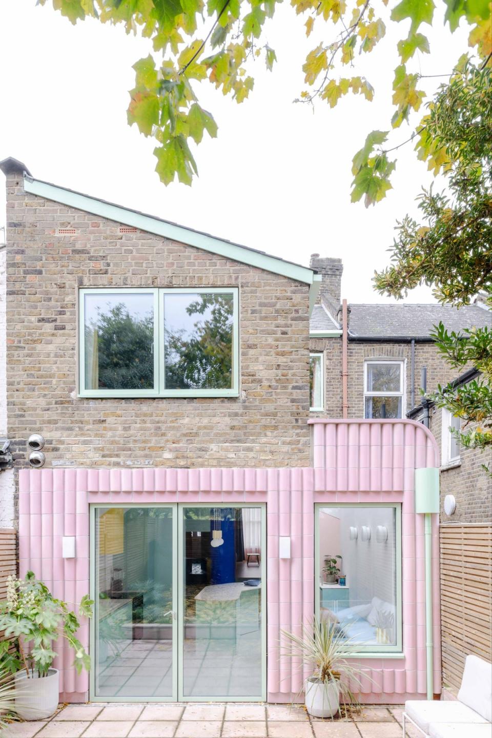 Beacon House by Office S+M features an extension covered in pink curving tiles (French + Tye)