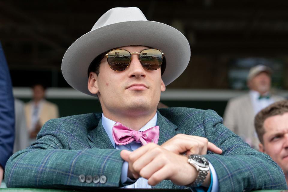 May 4, 2024; Louisville, KY, USA; Tye Herbstreit watches the second race during the 150th running of the Kentucky Derby at Churchill Downs. Mandatory Credit: Clare Grant-USA TODAY Sports