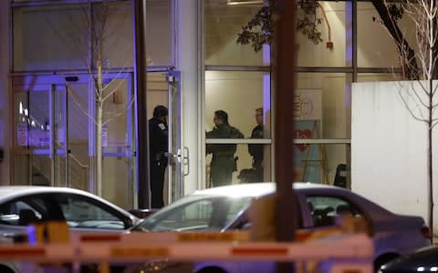 Police officers stand at one of the entrances at Mercy Hospital - Credit: Getty