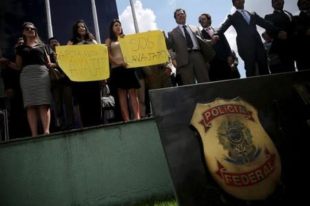 Heads of the federal police office in Sao Paulo take part in support to the Operation Car Wash "Lava Jato" in front of headquarters of Federal Police in Sao Paulo, Brazil, March 18, 2016. The signs read "We support to Operation Car Wash". REUTERS/Nacho Doce