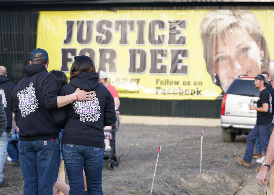 People look at a "Justice for Dee" banner during a vigil April 23, 2022, at Hardy Farms in Tipton. Lenawee County Probate Judge Catherine A. Sala ruled Monday that Dee Warner is dead.