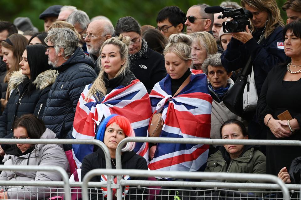 <p>Members of the public wait for the passage of the coffin along the Procession Route in London on September 19, 2022, during the State Funeral Service of Britain's Queen Elizabeth II. - Leaders from around the world attended the state funeral of Queen Elizabeth II. The country's longest-serving monarch, who died aged 96 after 70 years on the throne, was honoured with a state funeral on Monday morning at Westminster Abbey. (Photo by Paul ELLIS / POOL / AFP) (Photo by PAUL ELLIS/POOL/AFP via Getty Images)</p> 