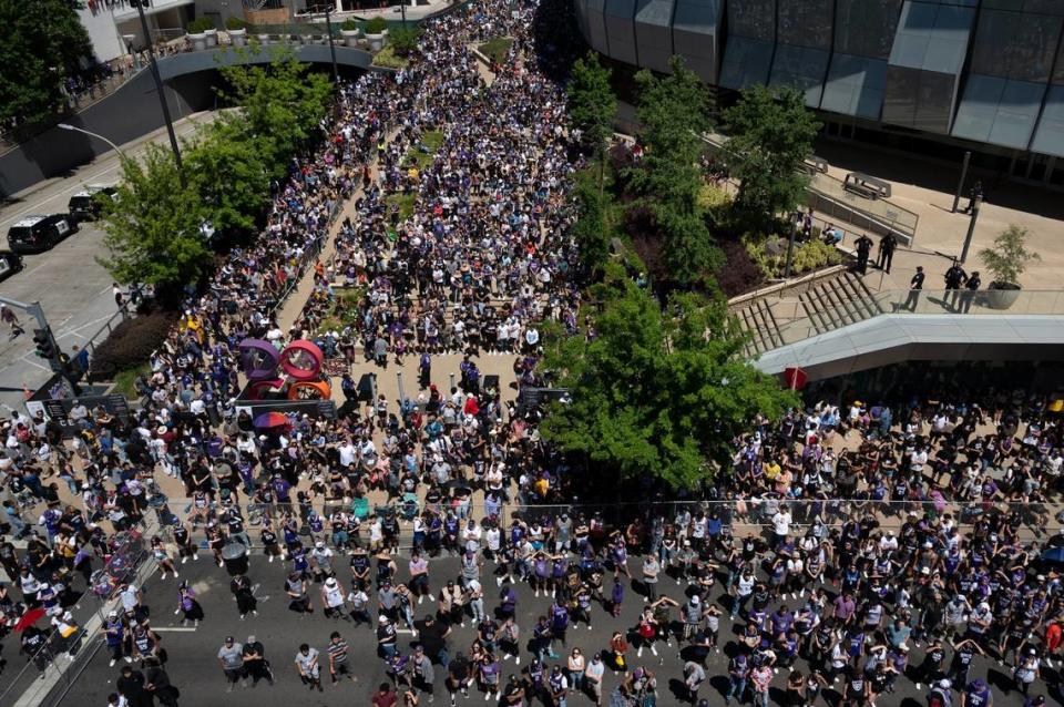 Fans watch the game on three big screens on the garage on L Street in the outdoor Section 916 watch party area as a crowd fills the Downtown Commons plaza in Sacramento during the first half of Game 7 of the NBA playoff series between the Sacramento Kings and the Golden State Warriors on Sunday, April 30, 2023.