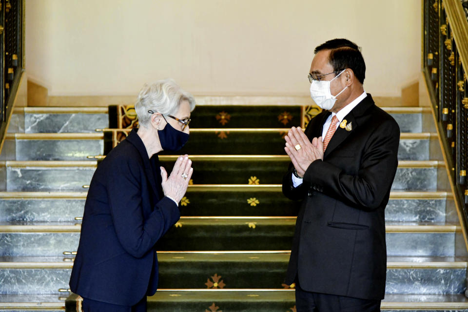 In this photo released by Government Spokesman Office, U.S. Deputy Secretary of State Wendy R. Sherman, left, and Thailand's Prime Minister Prayuth Chan-ocha, right, give the traditional greeting or "wai" at Government House in Bangkok, Thailand, Wednesday, June 2, 2021. (Government Spokesman Office via AP)