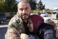 A Syrian couple mourns the loss of their daughter as her body is transferred to Syria, from the Turkish crossing point of Cilvegozu, in Reyhanli, southeastern Turkey, Thursday, Feb. 9, 2023. Rescuers pulled more survivors from beneath the rubble of collapsed buildings Thursday, but hopes were starting to fade for finding many more people alive more than three days after a catastrophic earthquake and series of aftershocks hit Turkey and Syria. (AP Photo/Hussein Malla)