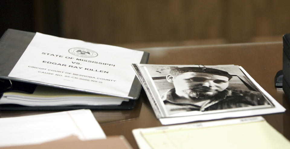 A photo of murdered civil rights worker Michael Schwerner, sits besides a "play book" used by the prosecution against Edgar Ray Killen, who is on trial for the 1964 deaths of three civil rights workers, including Schwerner, June 16, 2005. Stephen Schwerner doesn't remember how he learned that his younger brother Michael, nicknamed Mickey, was missing in Mississippi along with colleagues Andrew Goodman and James Chaney. What he remembers is that as soon as the family heard the news, they were certain of their fate: "We were sure they were killed," he says. It was the summer of 1964, an era marked by murders, beatings, disappearances and church bombings amid the struggle for voting rights and the fight against segregation. (AP Photo/Rogelio Solis, Pool)