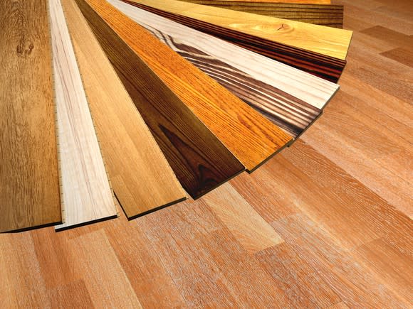 A display of wooden laminate planks in a variety of colors