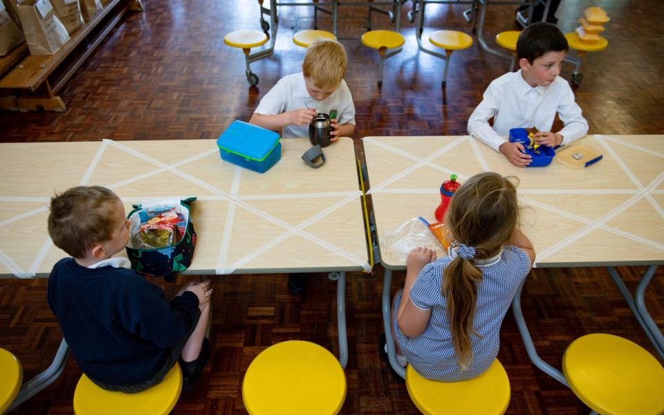 Children of essential workers eat lunch in segregated positions at Kempsey Primary School in Worcester. Nursery and primary pupils could return to classes from June 1 following the announcement of plans for a phased reopening of schools. PA Photo. Picture date: Monday May 18, 2020 -  Jacob King/PA Wire