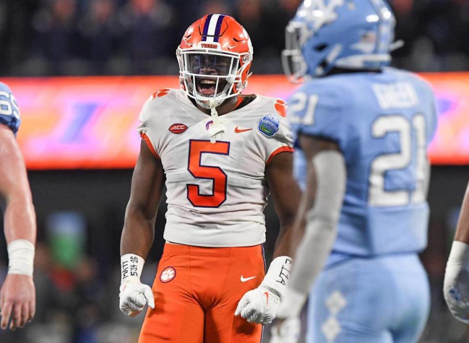Clemson defensive end K.J. Henry (5) celebrates a defensive play near North Carolina defensive back Dontavius Nash (21) during the first quarter of the ACC Championship football game at Bank of America Stadium in Charlotte, North Carolina Saturday, Dec 3, 2022.