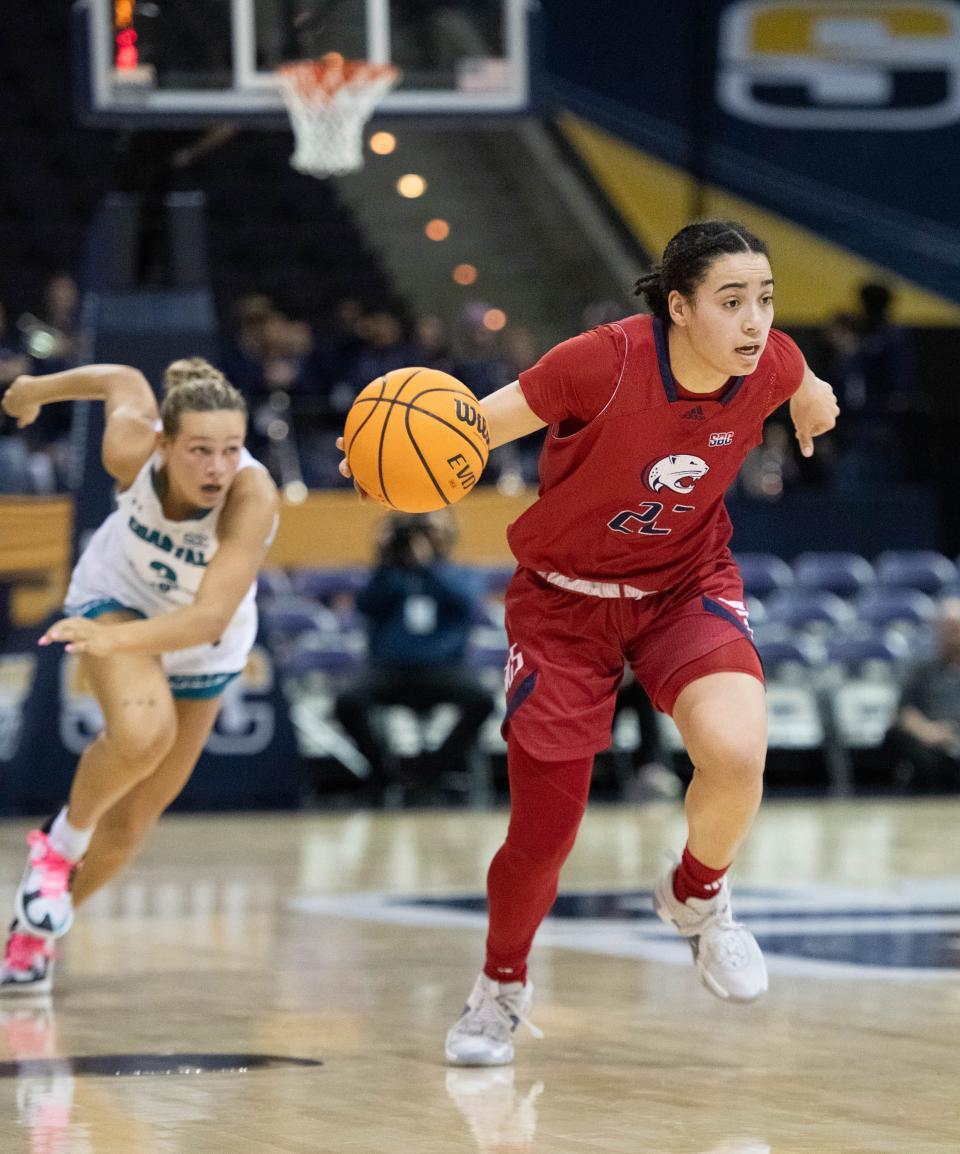 Former Navarre High School Raider Rachel Leggett (22) brings the ball up court during Coastal Carolina vs. South Alabama game in the first round of the Sun Belt Conference Women’s Basketball Championship at the Pensacola Bay Center on Tuesday, March 5, 2024.