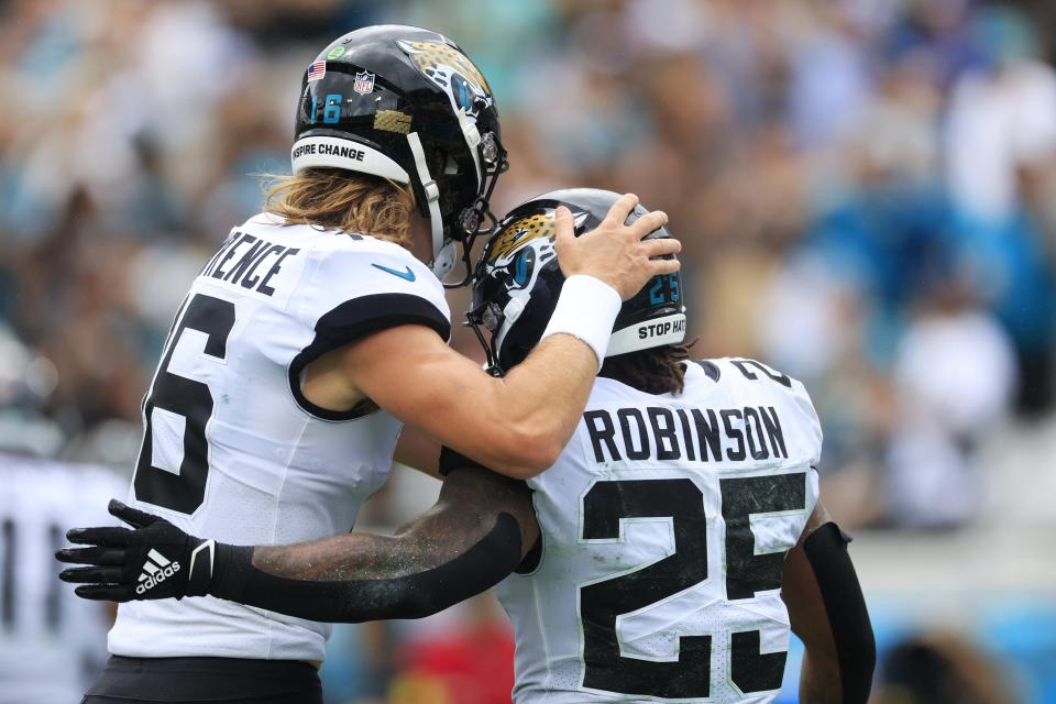 Jacksonville Jaguars quarterback Trevor Lawrence (16) hugs Jacksonville Jaguars running back James Robinson (25) for his touchdown score during the second quarter of a regular season game Sunday, Sept. 18, 2022 at TIAA Bank Field in Jacksonville. [Corey Perrine/Florida Times-Union]