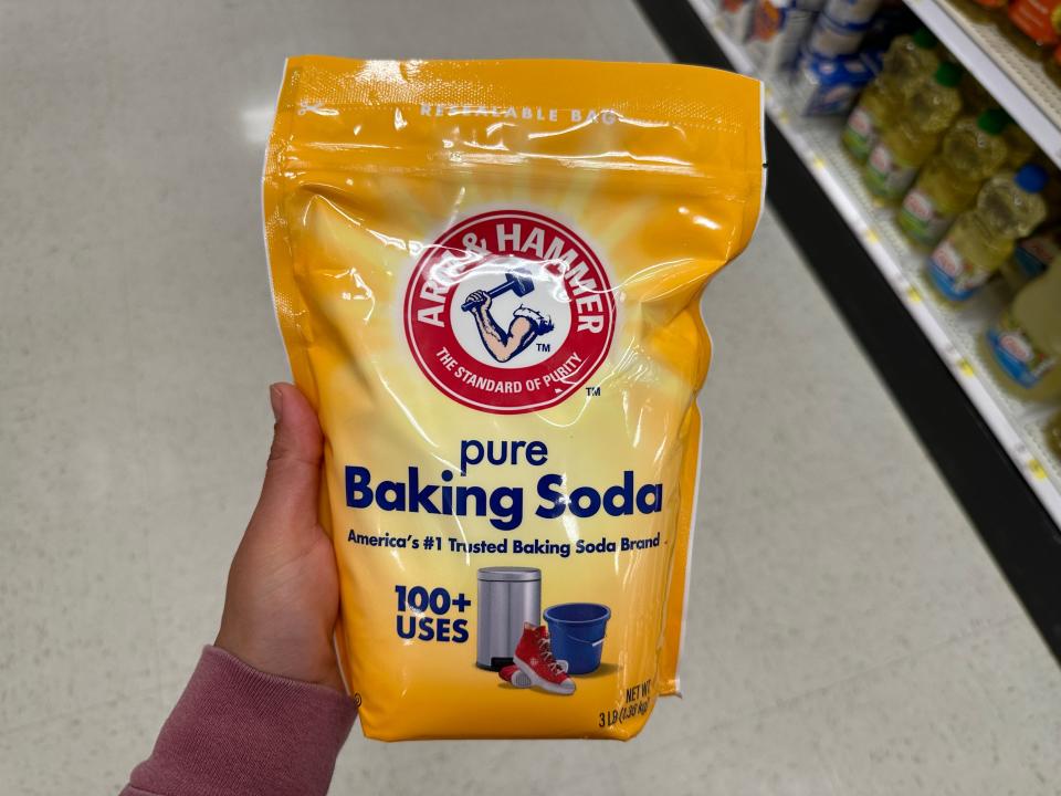 hand holding up a big bag of baking soda at target