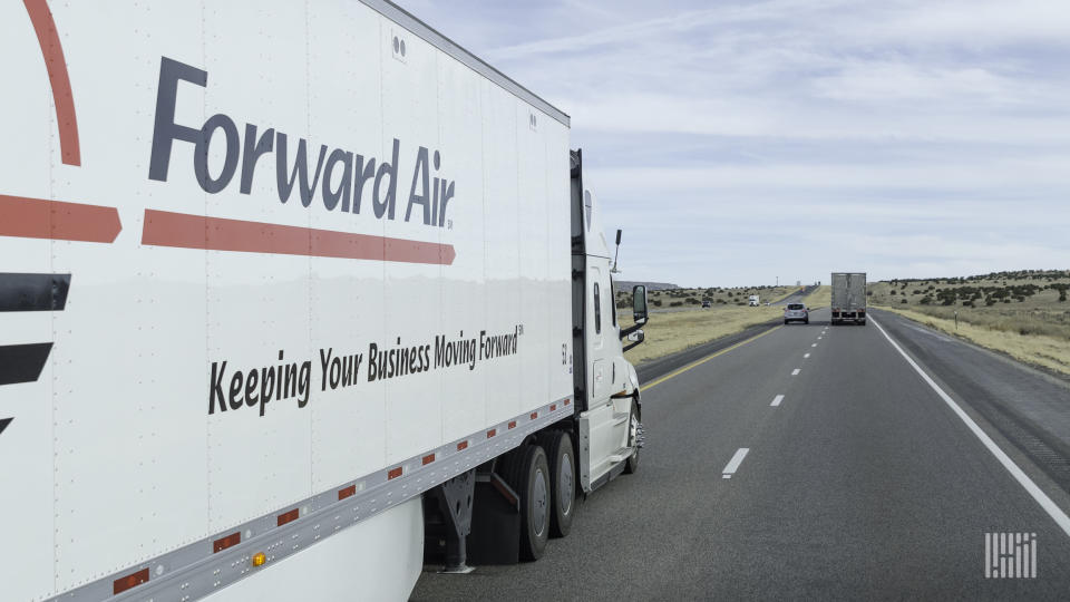 Side view of a Forward Air trailer being pulled on a highway