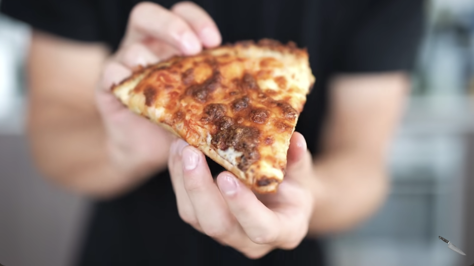 man holding a pizza slice