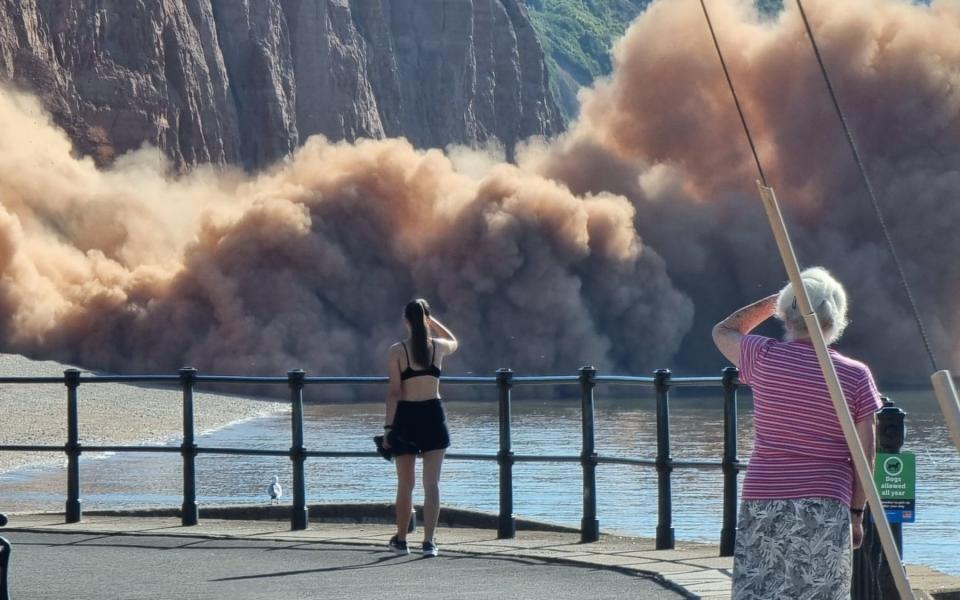 Walkers watched in horror as a large section of Sidmouth cliff, Devon, crashed onto the beach at 9.15am