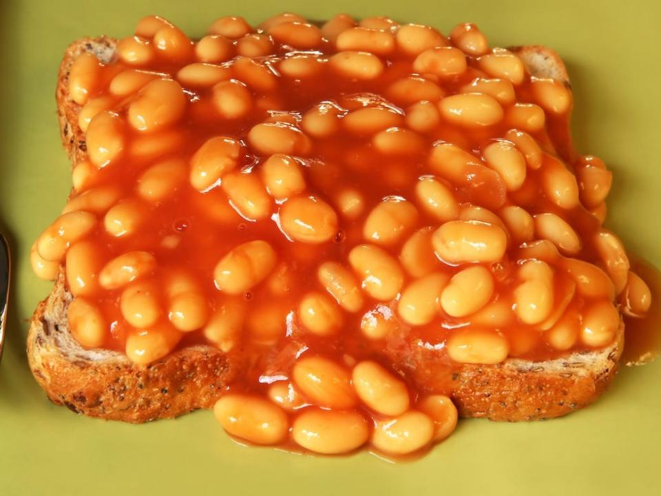 baked beans on toast on a green plate