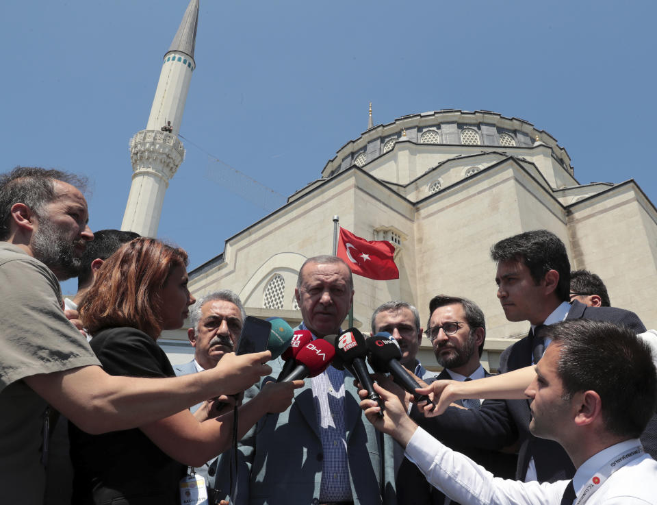 Turkish President Recep Tayyip Erdogan speaks to the media after Friday prayers, in Istanbul, Friday, June 7, 2019. Erdogan says his country is determined to protect Turkish Cypriots' rights to gas deposits in the eastern Mediterranean.(Presidential Press Service via AP, Pool)