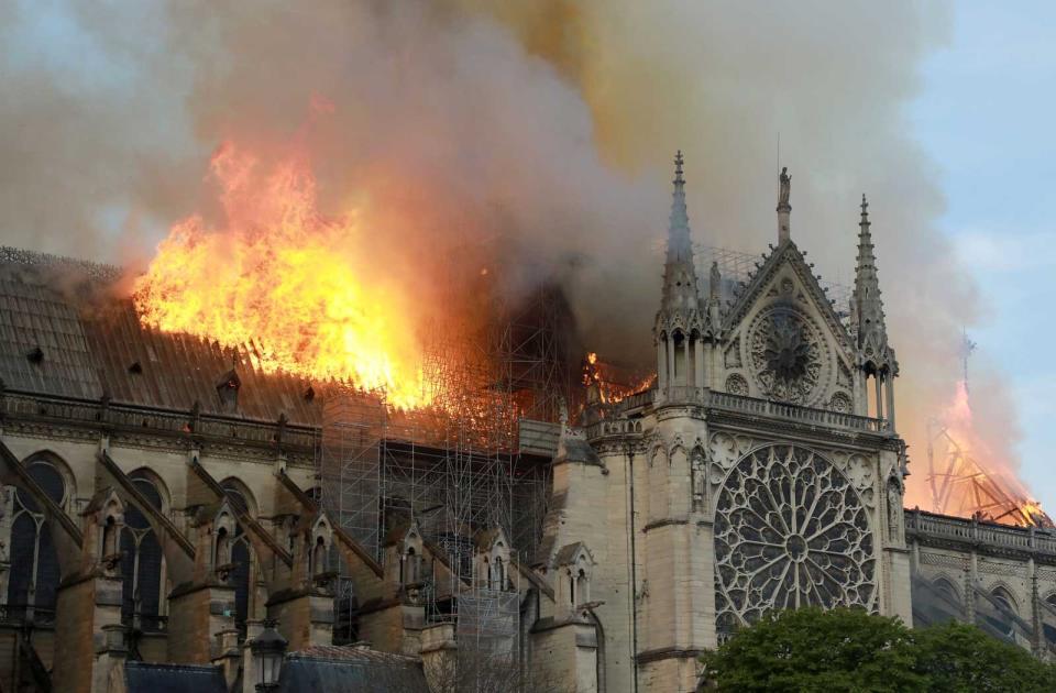 Flames and smoke are seen billowing from the roof at Notre-Dame Cathedral April 15, 2019 in Paris, France.