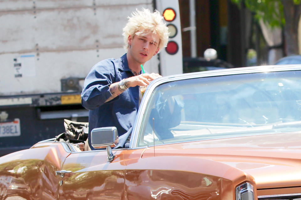 <p>Machine Gun Kelly rides around Los Angeles on Tuesday, one day after the rapper was <a href="https://people.com/movies/megan-fox-and-machine-gun-kelly-seen-kissing-after-brian-austin-green-courtney-stodden-step-out/" rel="nofollow noopener" target="_blank" data-ylk="slk:spotted kissing;elm:context_link;itc:0;sec:content-canvas" class="link ">spotted kissing</a> new love interest Megan Fox. </p>