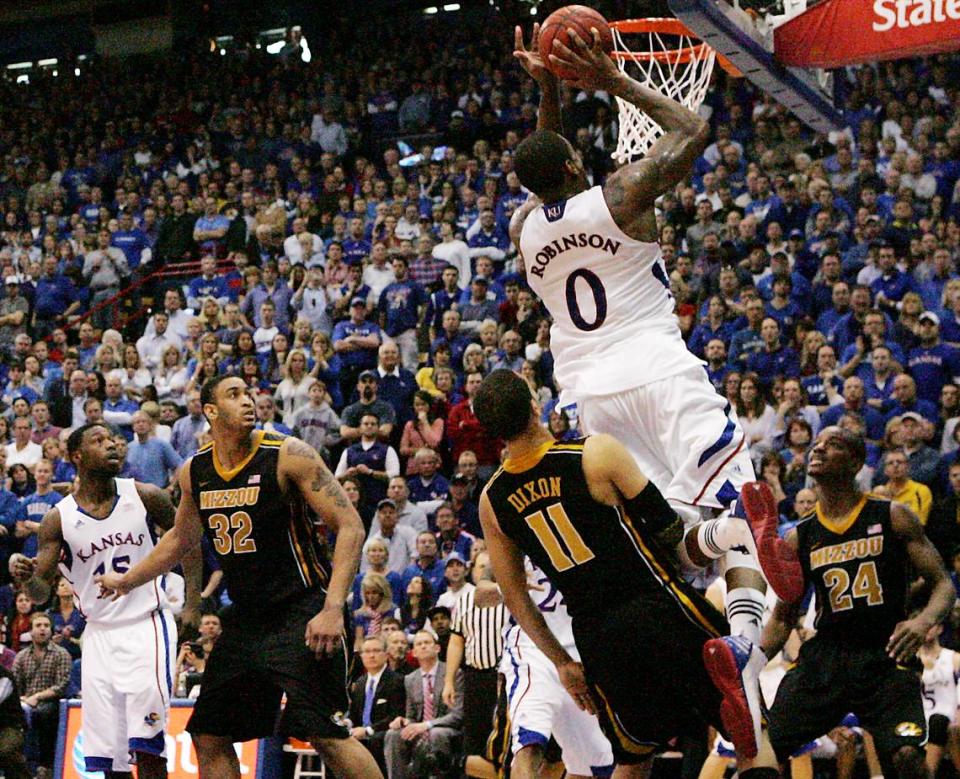 KU’s Thomas Robinson slipped past MU’s Michael Dixon and completed a three-point play to help the Jayhawks tie the score in regulation on Feb. 25, 2012 at Allen Fieldhouse. KU won 87-86 in overtime.