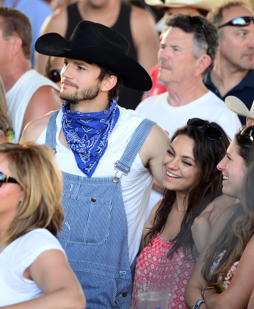 Ashton Kutcher (L) and Mila Kunis attend day 2 of 2014 Stagecoach: California's Country Music Festival at the Empire Polo Club on April 26, 2014 in Indio, California