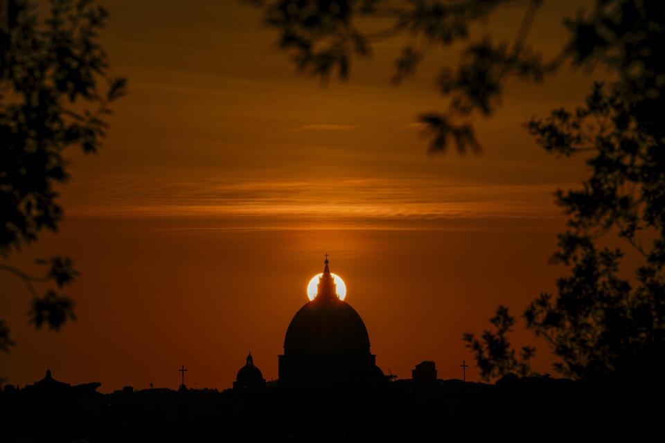 FILE - The sun sets behind the dome of St. Peter's Basilica, in Rome, on Feb. 20, 2023. Pope Gregory XIII, the 16th century pontiff responsible for what is today known as the Gregorian calendar, now has another, celestial claim to fame. A working group of the International Astronomical Union has named an asteroid after him, the Vatican Observatory said Tuesday, Feb. 28, 2023. The "560974 Ugoboncompagni" (Gregory's birthname was Ugo Boncompagni) was announced in the Feb. 27 update of the union's Working Group for Small Bodies Nomenclature. (AP Photo/Andrew Medichini, File)