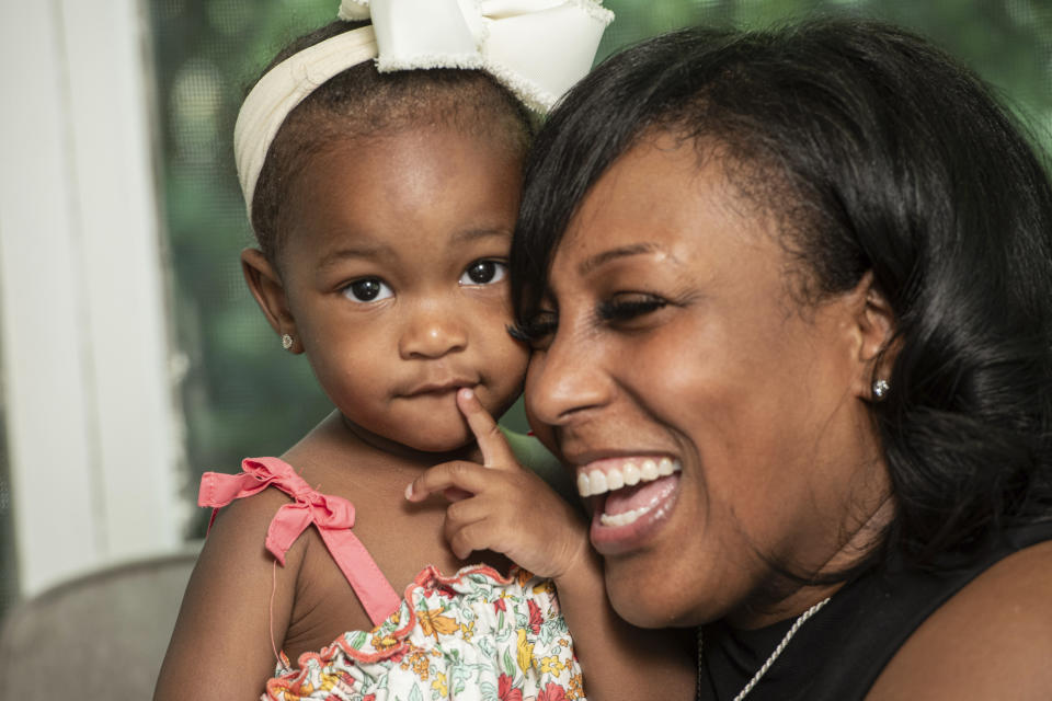 Raquel Robinson poses with her one-year-old daughter Londyn Crenshaw at their home in Cleveland Heights, Ohio, Wednesday, June 12, 2024. After her daughter was born in October 2022, Robinson was diagnosed with postpartum depression. (AP Photo/Phil Long)