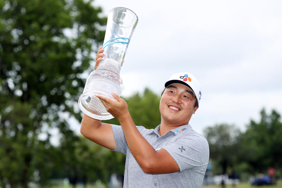 K.H. Lee of South Korea celebrates with the trophy after winning the 2021 AT&T Byron Nelson