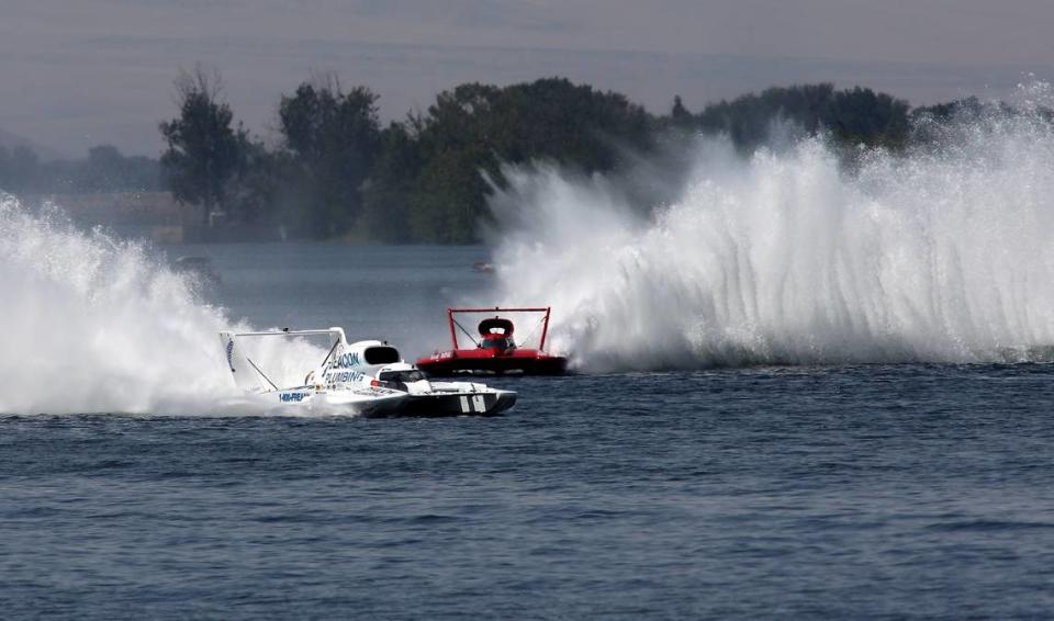 Driver Corey Peabody in the U-9 Miss Beacon Plumbing unlimited hydroplane outruns his teammate J. Michael Kelly in the Miss Beacon Electric to claim the checker flag in Heat 3A of the Columbia Cup race. Bob Brawdy/bbrawdy@tricityherald.com