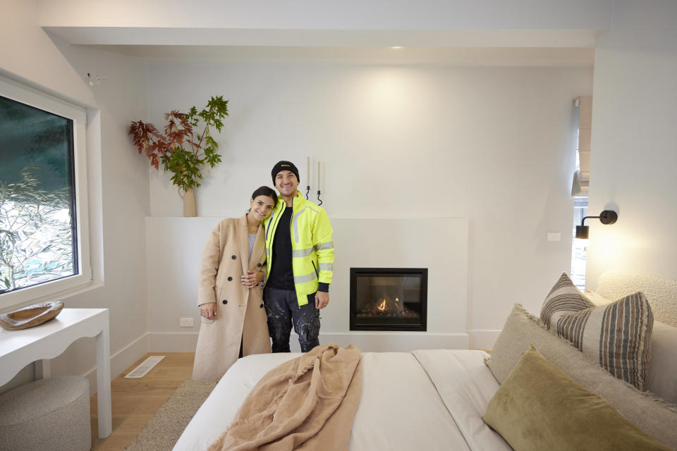 Steph and Gian pose in their guest bedroom.