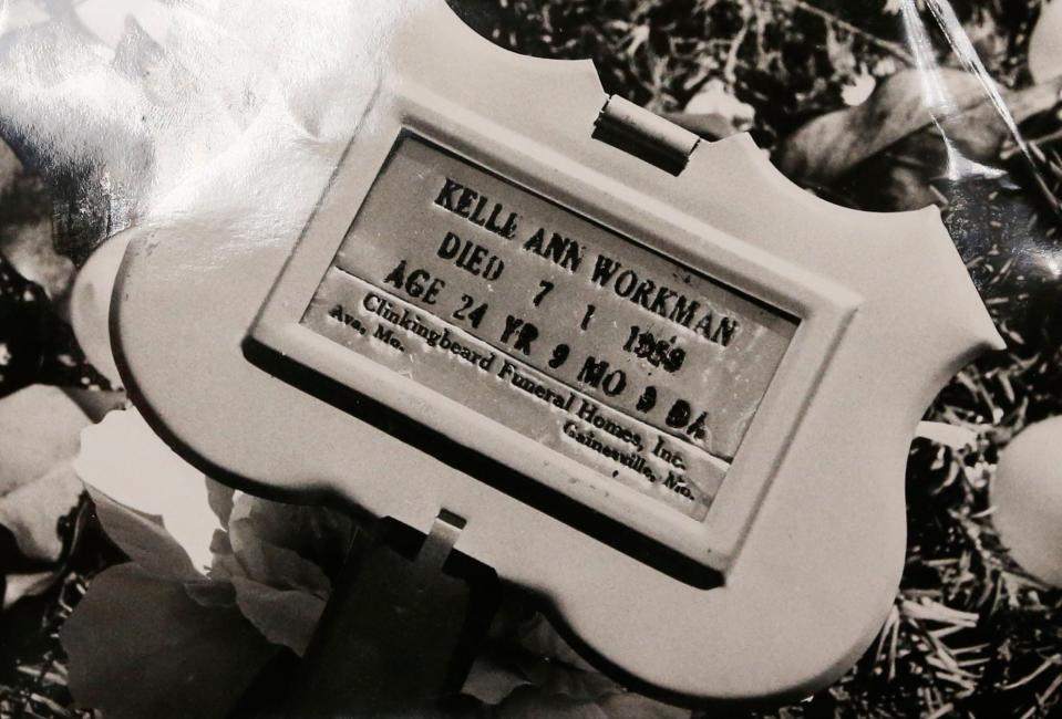 A black-and-white photograph of Kelle Ann Workman's memorial plate. Workman was 24 years old when she went missing on June 30, 1989. Her body was found days later in the Mark Twain National Forest on July 7, 1989.