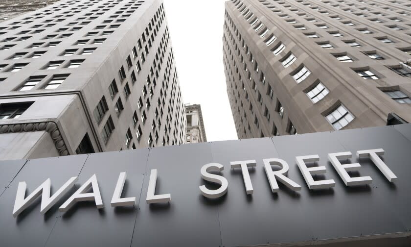 FILE - In this Aug. 31, 2020 file photo, buildings line Wall Street, in New York. Stocks are opening higher on Wall Street Thursday, Sept. 10 as the market claws back some more of the ground it lost in a three-day slump that snapped a day earlier. (AP Photo/Mark Lennihan, File)