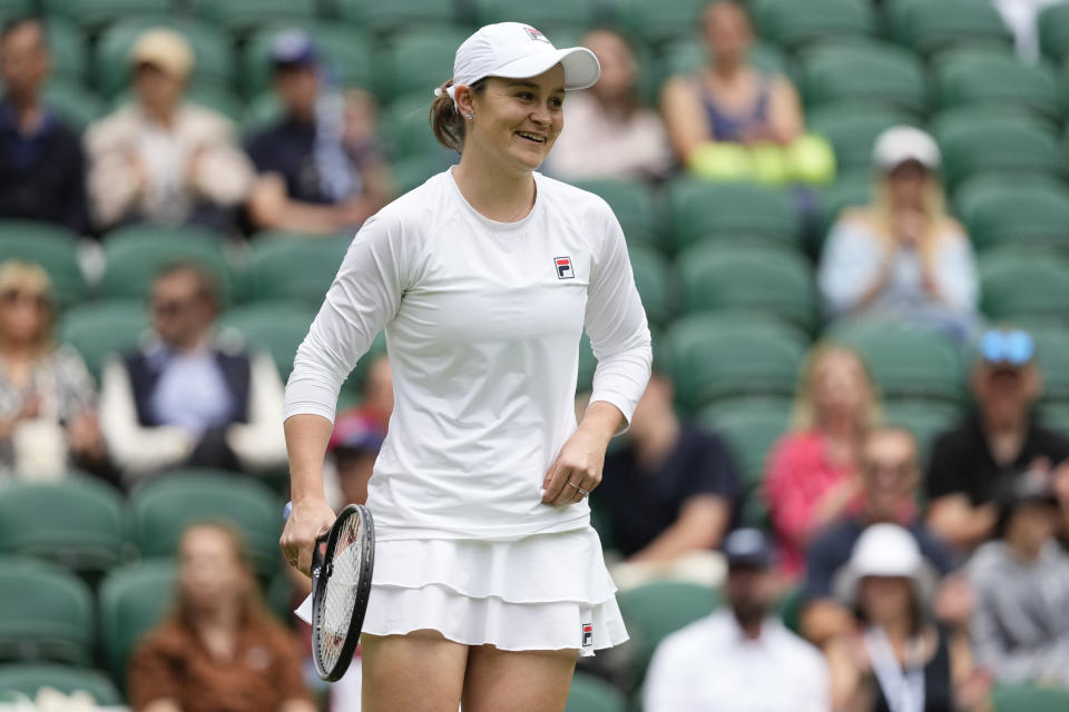 Australia's Ash Barty reacts during her invitation doubles match with compatriot Casey Dellacqua against Andrea Petkovic of Germany and Magdelena Rybarikova of Slovakia at the Wimbledon tennis championships in London, Wednesday, July 10, 2024. (AP Photo/Kirsty Wigglesworth)