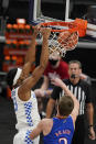 Kentucky's Isaiah Jackson (23) dunks against Kansas' Christian Braun (2) during the first half of an NCAA college basketball game Tuesday, Dec. 1, 2020, in Indianapolis. (AP Photo/Darron Cummings)