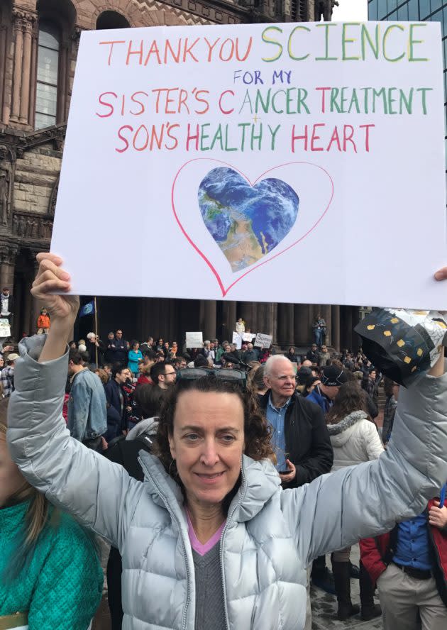 Anne Drowns holds up a sign at Boston’s “Stand Up for Science” rally. (GeekWire Photo / Alan Boyle)