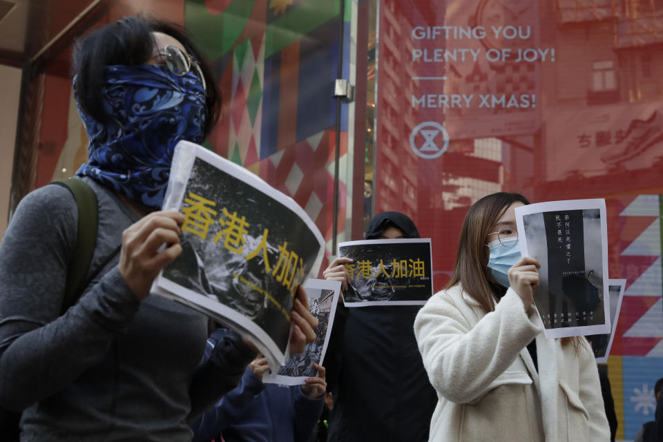 Pro-democracy supporters and office workers protest in Causeway Bay in Hong Kong, Wednesday, Dec. 11, 2019. Hong Kong Chief Executive Carrie Lam on Tuesday again ruled out further concessions to protesters who marched peacefully in their hundreds of thousands this past weekend, days before she is to travel to Beijing for regularly scheduled meetings with Communist Party leaders. (AP Photo/Mark Schiefelbein)