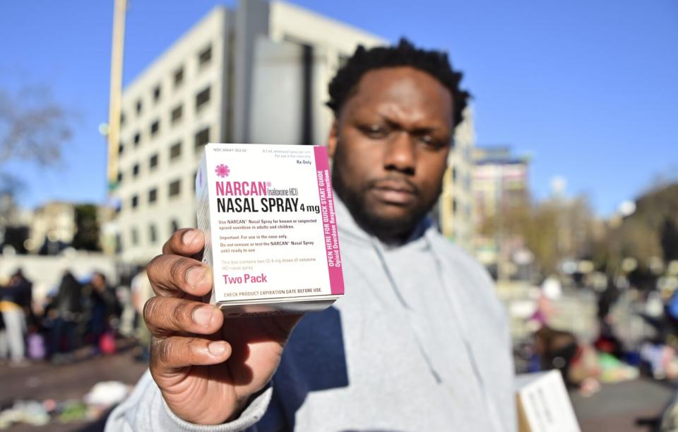 Roiri Jones of HealthRIGHT 360 displays a box of Narcan that he offers to drug users at UN Plaza in San Francisco.