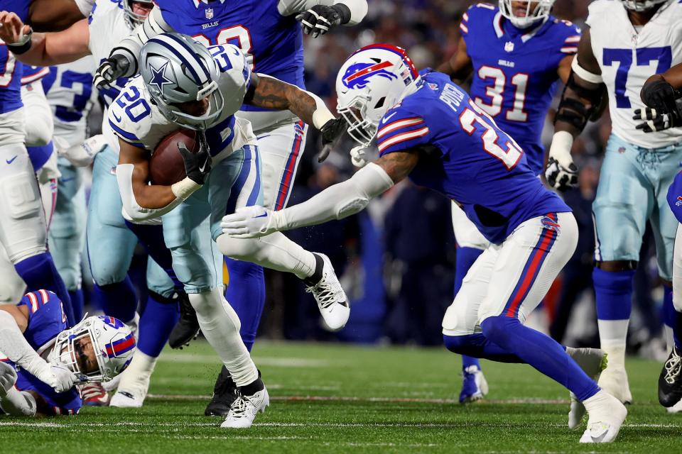 ORCHARD PARK, NEW YORK - DECEMBER 17: Jordan Poyer #21 of the Buffalo Bills tackles Tony Pollard #20 of the Dallas Cowboys during the second quarter at Highmark Stadium on December 17, 2023 in Orchard Park, New York. (Photo by Timothy T Ludwig/Getty Images)