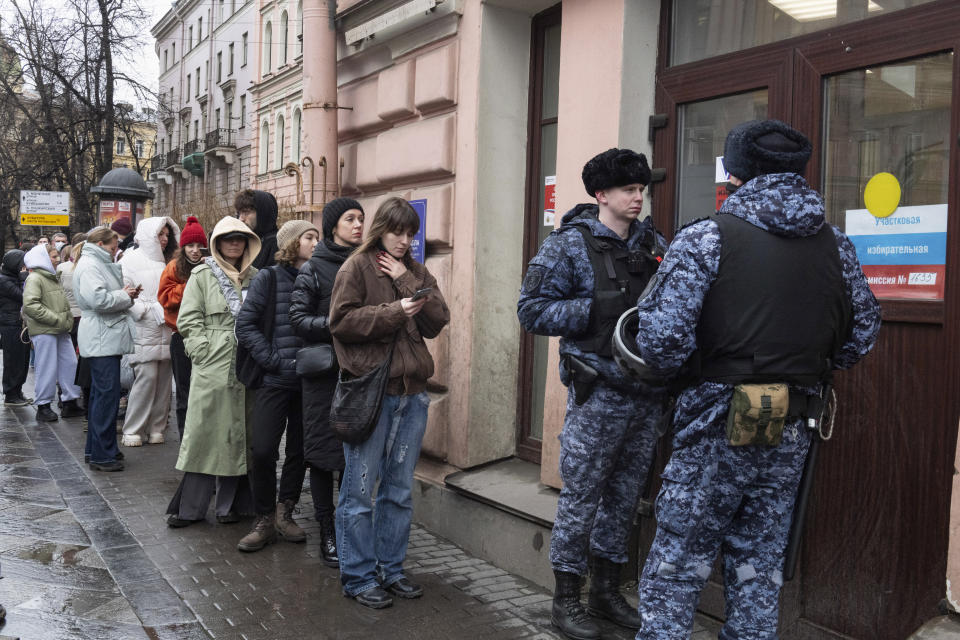 Voters queue at a polling station in St. Petersburg, Russia, at noon local time on Sunday, March 17. The Russian opposition has called on people to head to polling stations at noon on Sunday in protest as voting takes place on the last day of a presidential election that is all but certain to extend President Vladimir Putin's rule after he clamped down on dissent. AP can't confirm that all the voters seen at the polling station at noon were taking part in the opposition protest. (AP Photo)