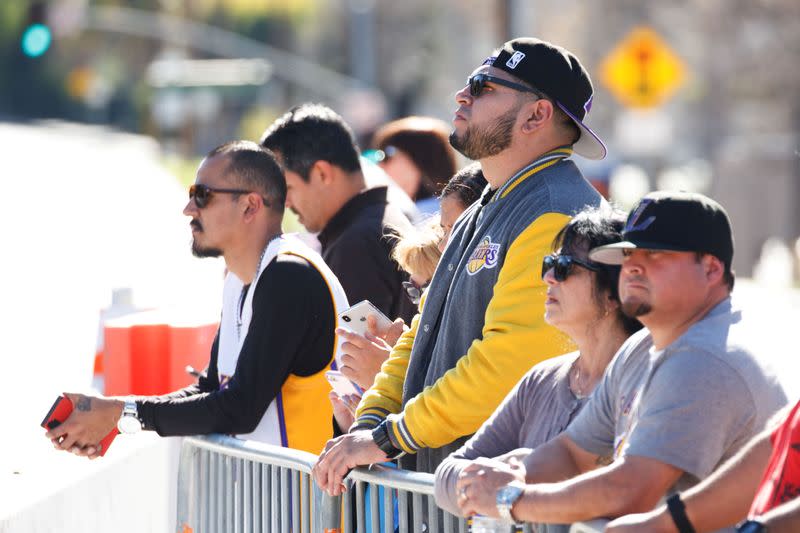 Lakers fans pay their respects across the street from the helicopter crash site of NBA star Kobe Bryant in Calabasas