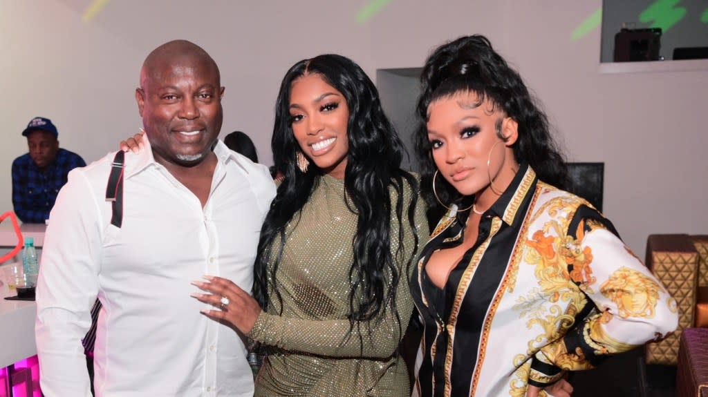 Simon Guobadia, Porsha Williams, and Drew Sidora posing together at a party