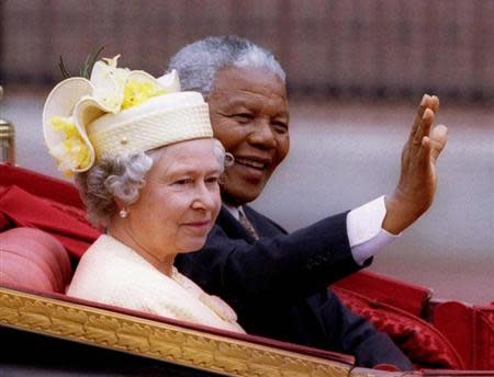 South African President Nelson Mandela is accompanied by Britain's Queen Elizabeth II in a carriage ride to a Buckingham Palace lunch on the first day of his state visit to Britain July 9.