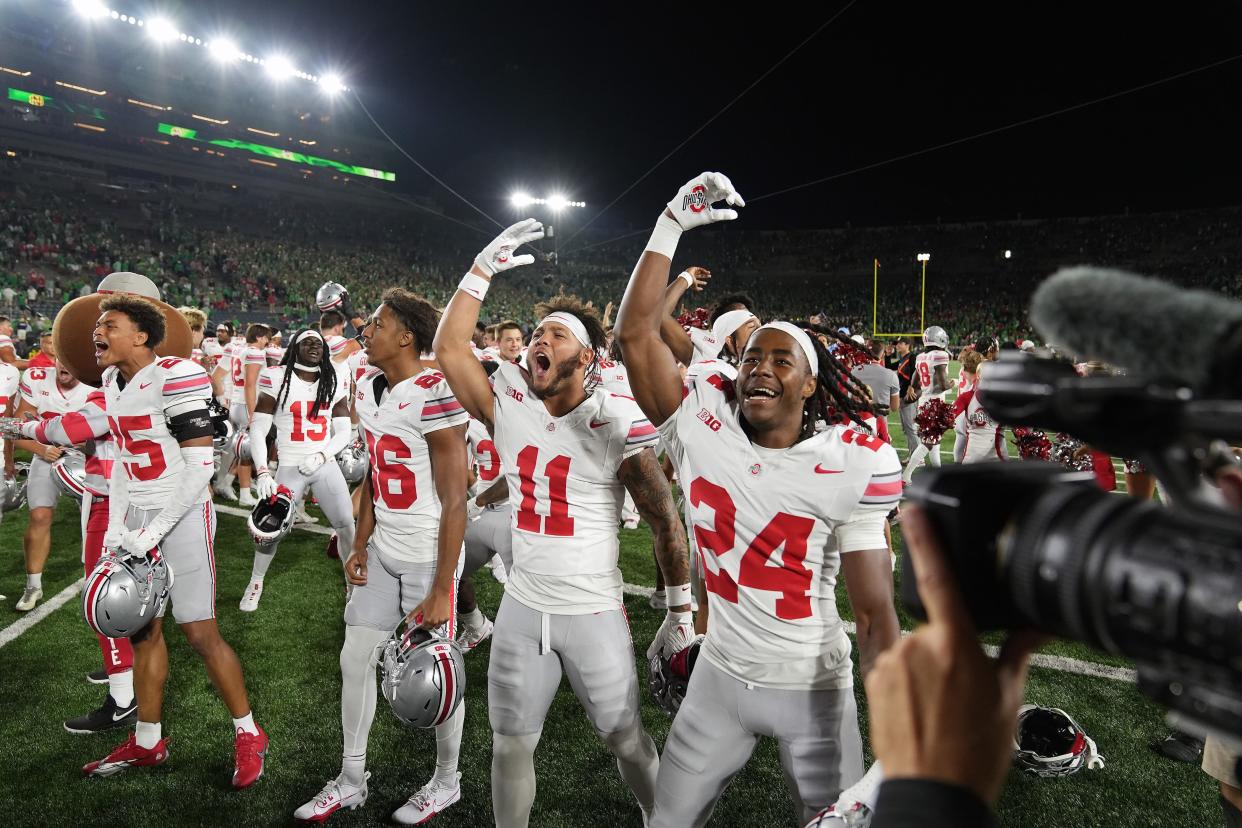 Sep 23, 2023; South Bend, Indiana, USA; Ohio State Buckeyes players Ohio State Buckeyes wide receiver Bryson Rodgers (86), wide receiver Brandon Inniss (11) and cornerback Jermaine Mathews Jr. (24) celebrate after beating Notre Dame Fighting Irish 17-14 at Notre Dame Stadium.