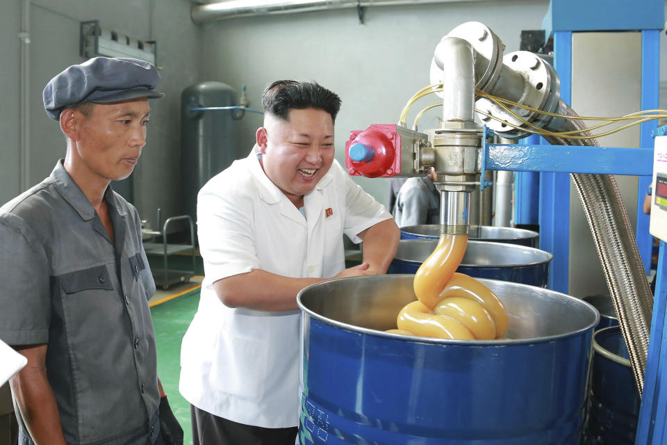 North Korean leader Kim Jong Un smiles during a visit to the Chonji Lubricant Factory in August of 2014.&nbsp;