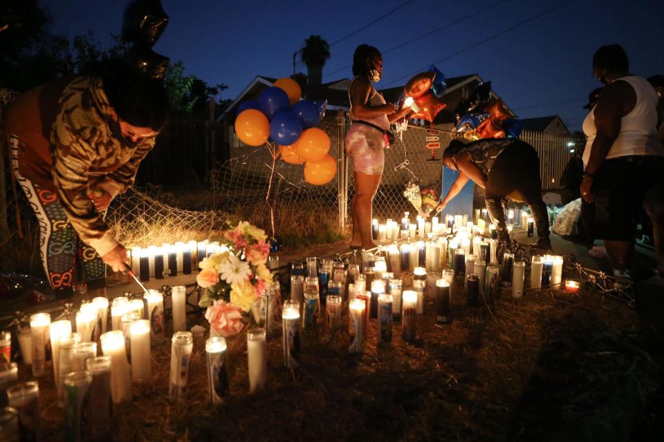 People gather and light candles at a makeshift memorial where Dijon Kizzee was killed (Getty Images)